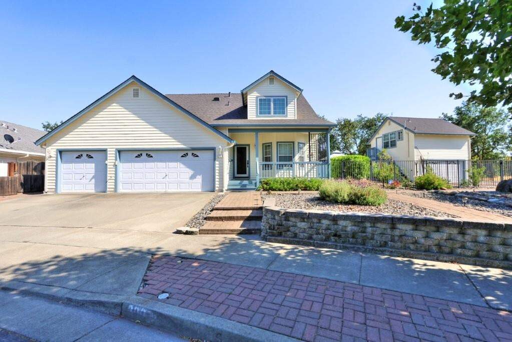 This sizeable lot boasts a 4 bedroom 2.5 bathroom main home with a 3-car garage--relax on your front porch.  In addition, there is  a detached 2-car garage with a guest flat and bathroom above. at 300 Creekside Way, Winters, CA 95694