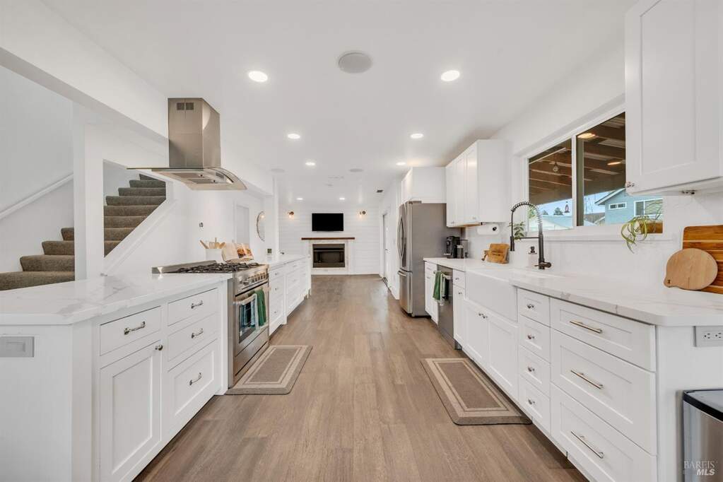 Plenty of room for everyone! Open concept remodeled kitchen w/custom cabinets, stainless appliances, farm sink, built in stereo speakers in ceiling, sitting area w/bar stools along back of range and counter area at 330 Brookshire Court, American Canyon, CA 94503