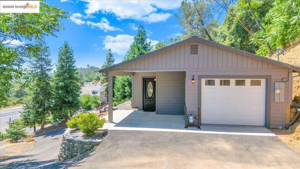View of front of house featuring an outdoor structure and a garage at 1160 S Washington St, Sonora, CA 95370