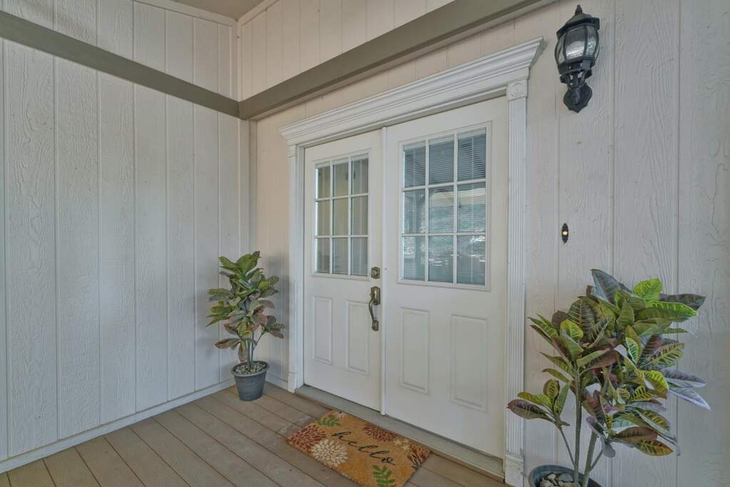 The entry to this home is lovely with a covered porch and double doors at 4420 Pleasant Valley Road #159, Diamond Springs, CA 95619