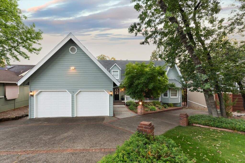 Gorgeous setting on a peaceful cul-de-sac with ample parking in drive/2 car attached garage and don't miss the additional parking BELOW with easy access for at least 2 more vehicles plus additional off street parking. at 12064 Waxwing Court, Penn Valley, CA 95946