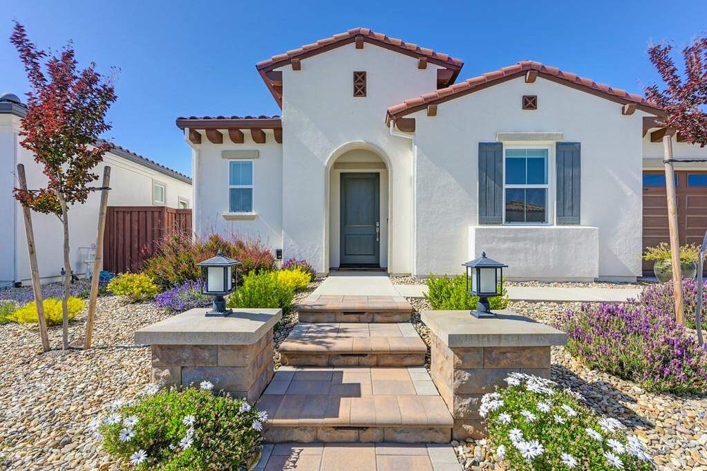 This  'Spanish' style Redwood  home has a warm and  welcoming entrance complete with added lighted stairs. at 4272 Grey Hawk Street, Folsom, CA 95630