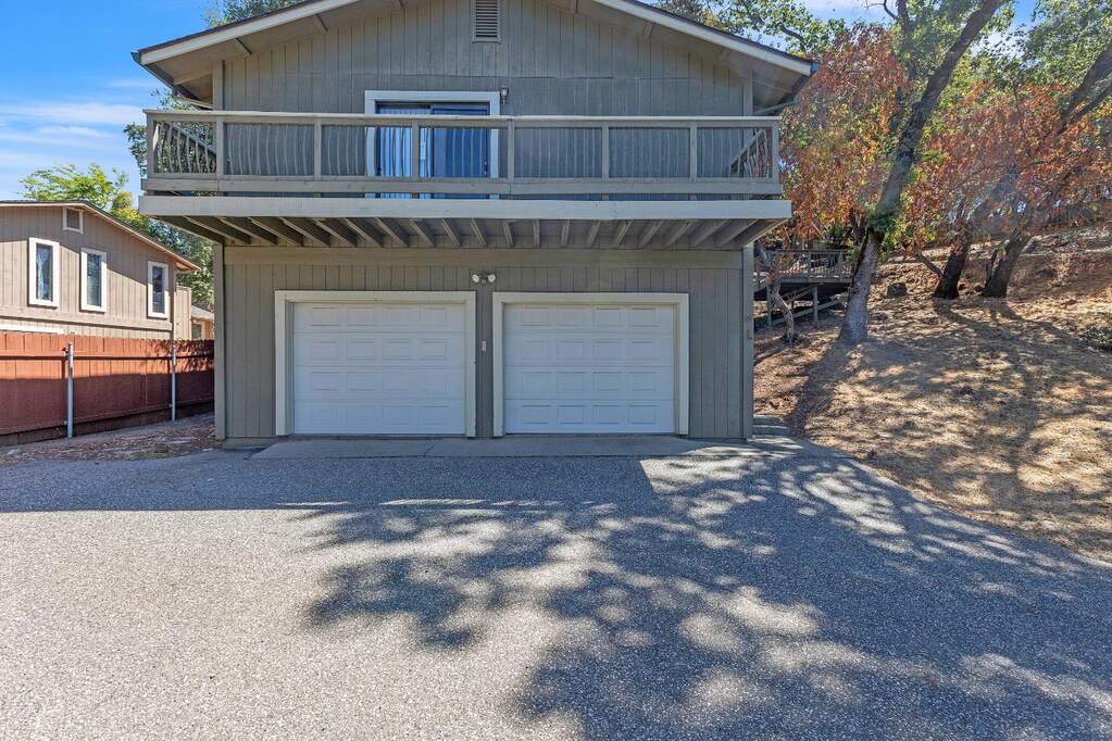 view of front of property featuring a garage and gravel driveway at 11203 Welty Lane, Auburn, CA 95603